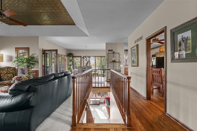 living room with visible vents, ceiling fan, and wood finished floors