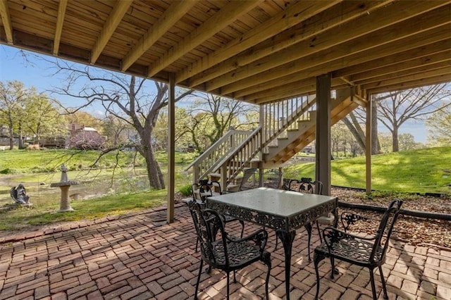 view of patio / terrace with outdoor dining area and stairway