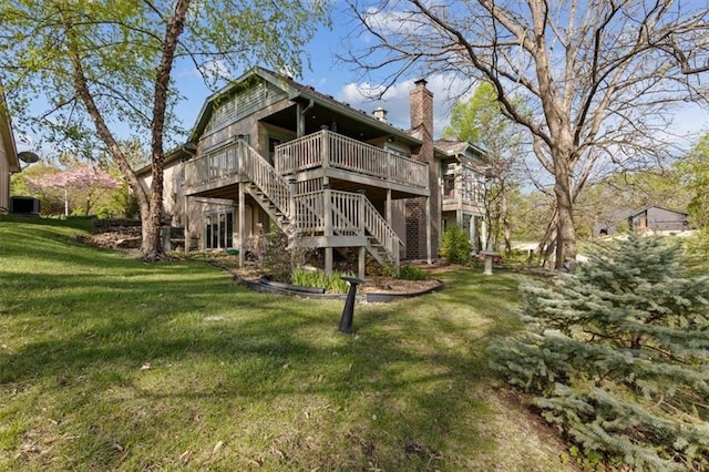 back of property featuring central air condition unit, a wooden deck, stairway, a chimney, and a lawn