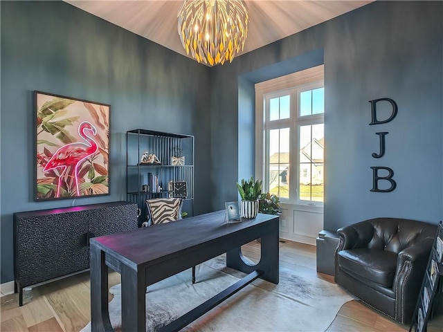 home office with an inviting chandelier and wood finished floors