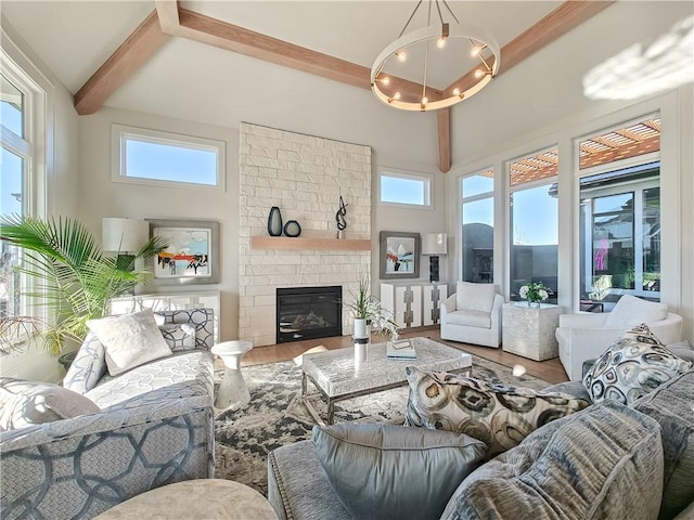 living room with a wealth of natural light, beamed ceiling, high vaulted ceiling, and wood finished floors