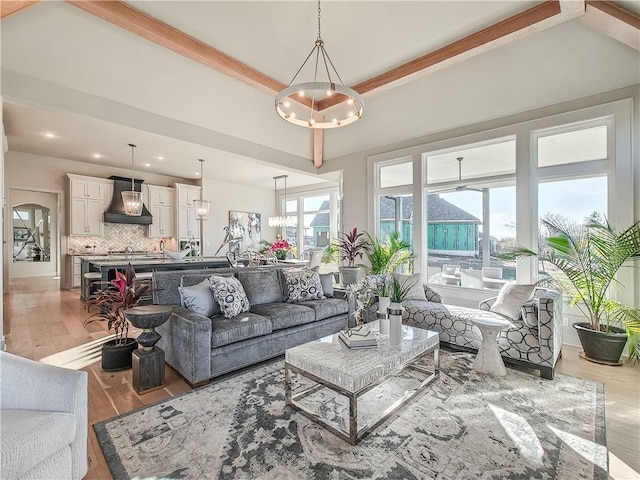 living room with an inviting chandelier, light wood-style flooring, plenty of natural light, and recessed lighting