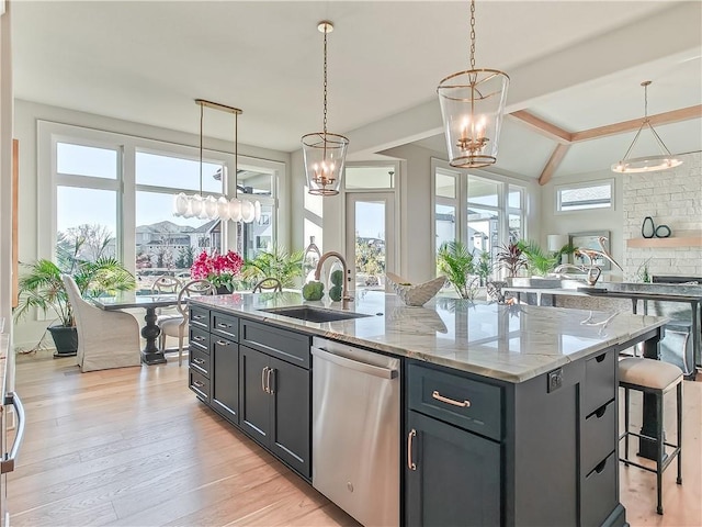 kitchen with a notable chandelier, a sink, light wood-style flooring, and stainless steel dishwasher