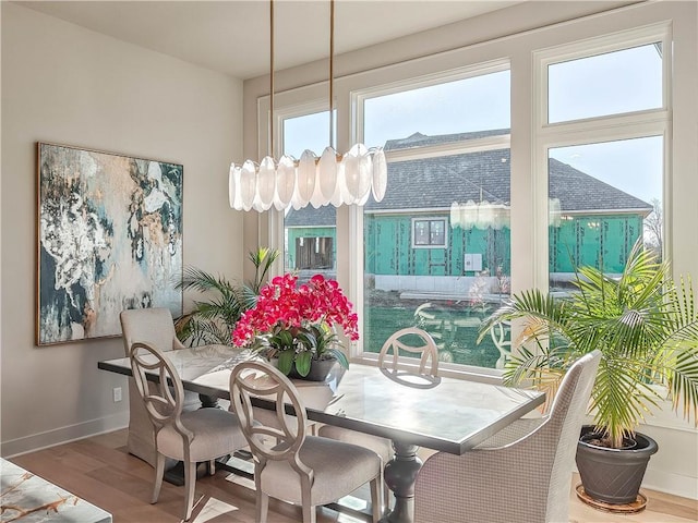 dining area featuring wood finished floors and baseboards