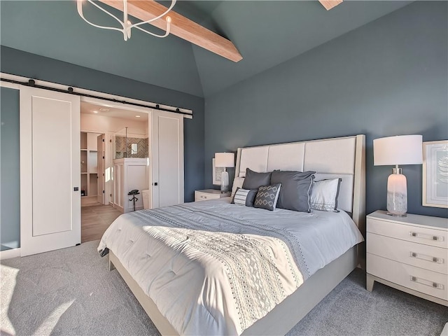 bedroom featuring a barn door, carpet, and vaulted ceiling