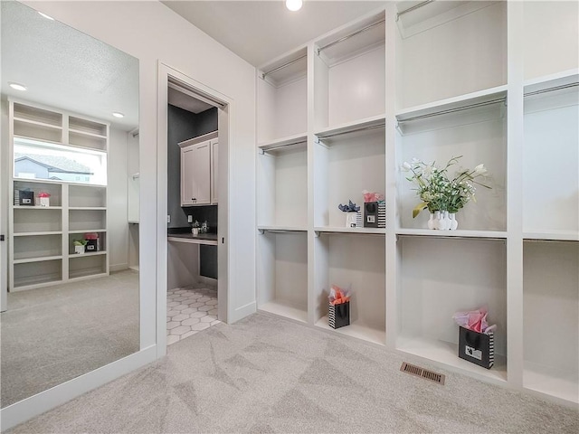 spacious closet with visible vents and carpet