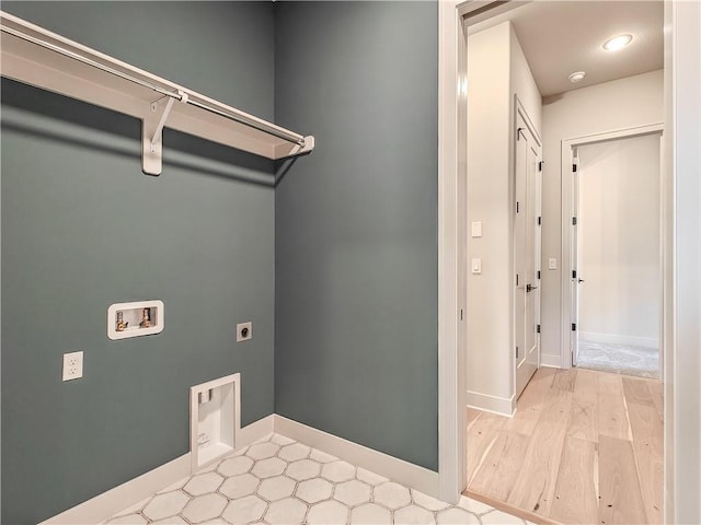 laundry area featuring baseboards, laundry area, hookup for a washing machine, wood finished floors, and electric dryer hookup