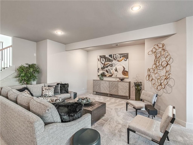 living area featuring carpet flooring and baseboards