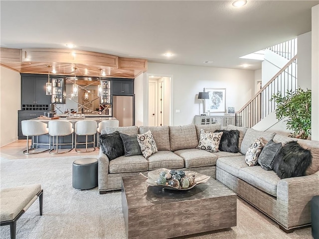 living area featuring bar, stairway, and recessed lighting