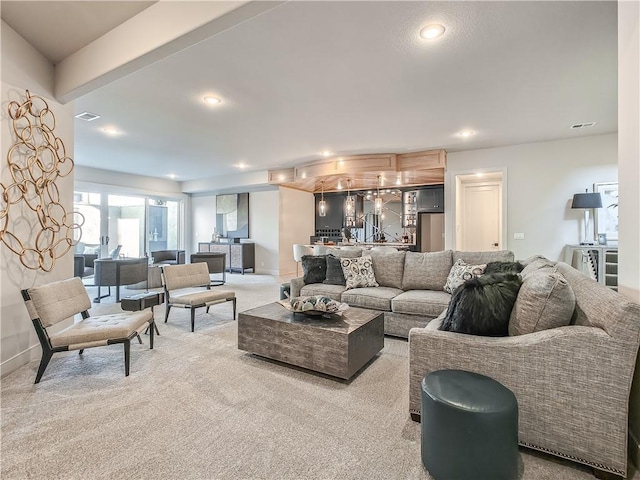 carpeted living room with recessed lighting, visible vents, and baseboards