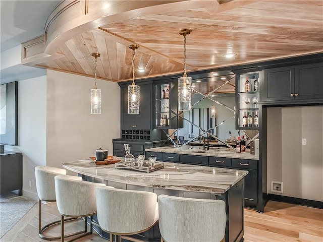 kitchen featuring a kitchen island, pendant lighting, wood ceiling, light wood-style flooring, and open shelves