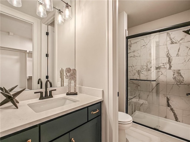 bathroom featuring vanity, toilet, and a shower stall