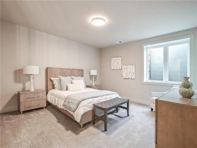 bedroom with visible vents, light colored carpet, and baseboards