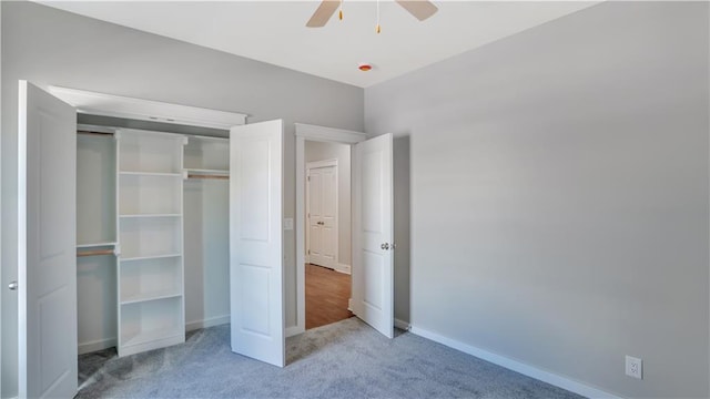 unfurnished bedroom featuring carpet, baseboards, a closet, and a ceiling fan