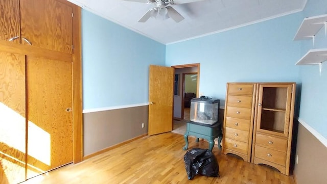 bedroom with a ceiling fan, light wood-style floors, and ornamental molding