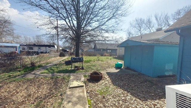 view of yard featuring fence and an outdoor fire pit