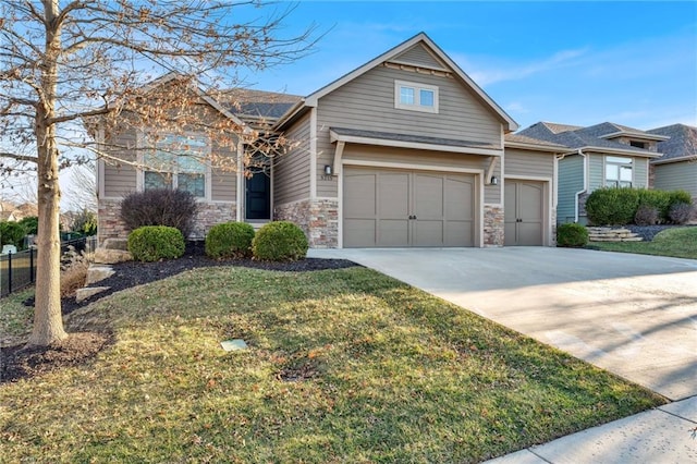 view of front of home with fence, an attached garage, concrete driveway, a front lawn, and stone siding