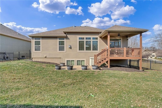 back of property with a yard, a fenced backyard, stairs, and a ceiling fan