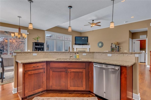 kitchen featuring open floor plan, dishwasher, light wood-type flooring, ceiling fan with notable chandelier, and a sink