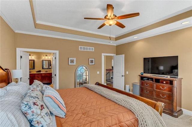 bedroom with visible vents, crown molding, a raised ceiling, and carpet