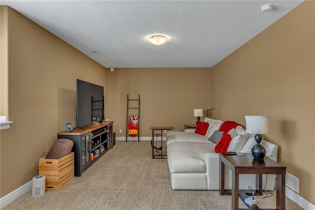 living room with visible vents, light colored carpet, a textured ceiling, and baseboards