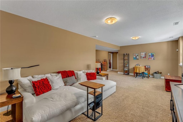 carpeted living room with visible vents, baseboards, and a textured ceiling