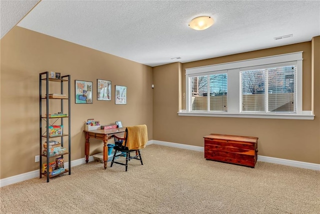 office area featuring visible vents, baseboards, a textured ceiling, and carpet flooring