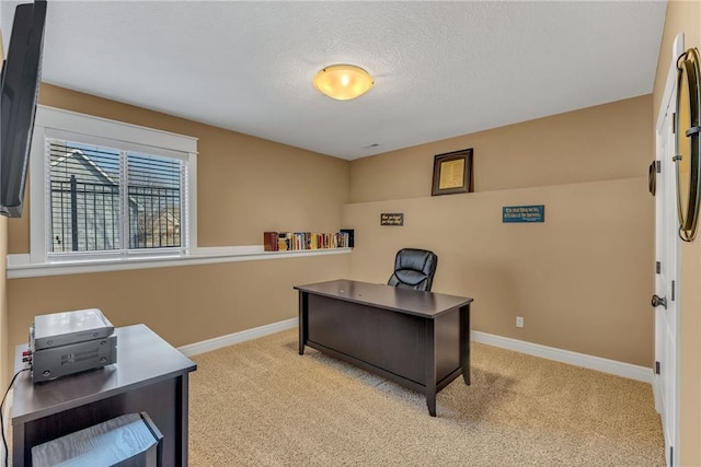 office space with baseboards, carpet floors, and a textured ceiling