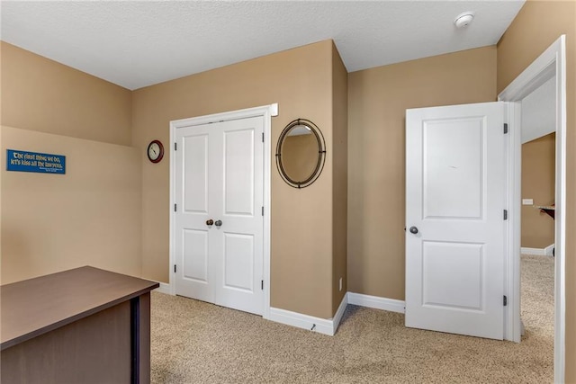 interior space with baseboards and carpet flooring