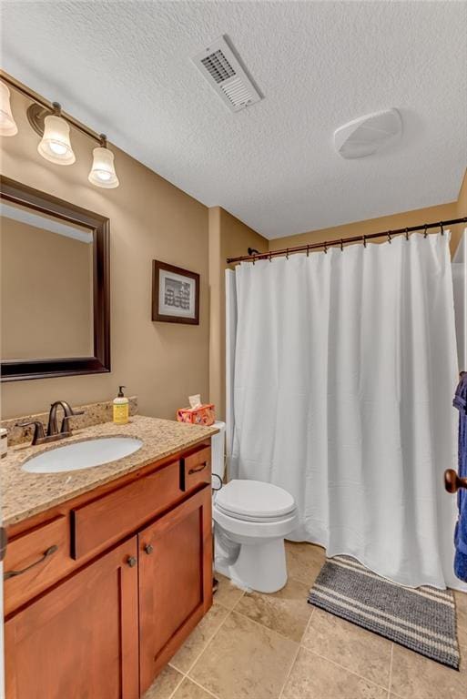 full bath featuring visible vents, toilet, a textured ceiling, and vanity