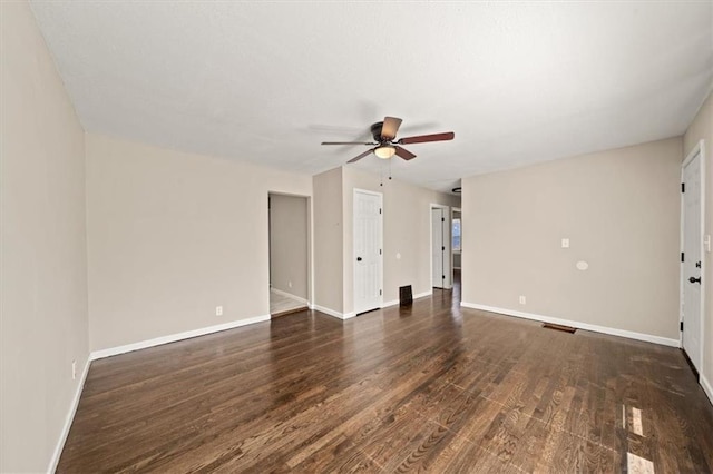 unfurnished living room with dark wood-type flooring, a ceiling fan, baseboards, and visible vents