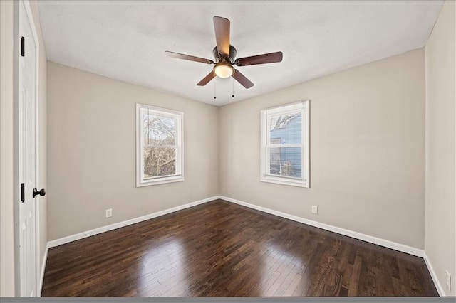 unfurnished room featuring ceiling fan, dark wood-type flooring, and baseboards