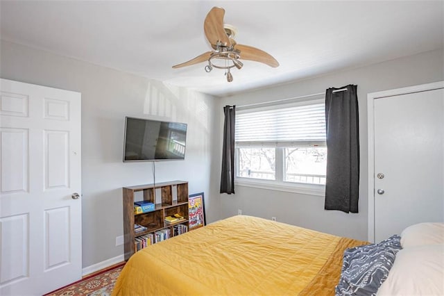 bedroom with baseboards and ceiling fan