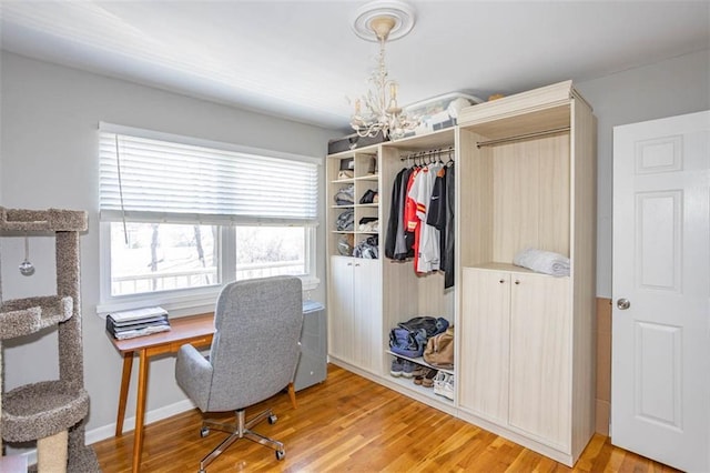 office space with light wood-style flooring, baseboards, and a chandelier