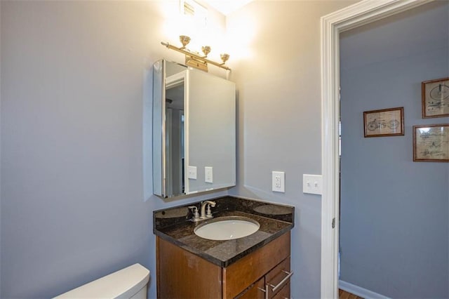 bathroom featuring toilet and vanity