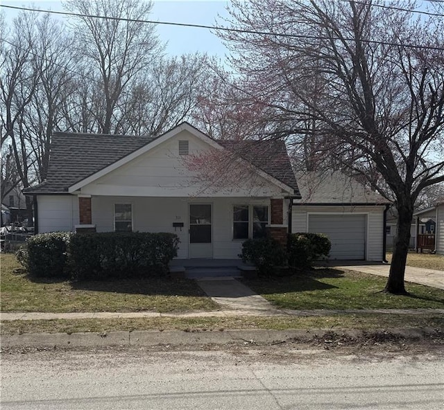 view of front facade with a garage, covered porch, driveway, and roof with shingles