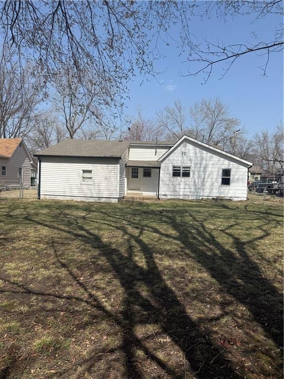 exterior space with a lawn and fence