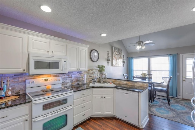 21212 E 52nd Street Ct, Blue Springs, MO 64015 - kitchen featuring a peninsula, dark wood finished floors, a sink, and white appliances
