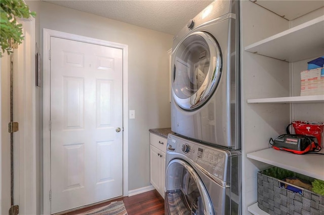 21212 E 52nd Street Ct, Blue Springs, MO 64015 - laundry area with dark wood finished floors, cabinet space, stacked washer / dryer, and a textured ceiling