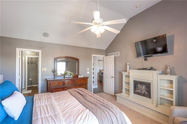 21212 E 52nd Street Ct, Blue Springs, MO 64015 - bedroom featuring a glass covered fireplace, lofted ceiling, visible vents, and baseboards