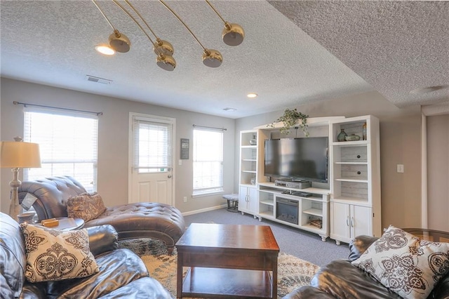 21212 E 52nd Street Ct, Blue Springs, MO 64015 - living area with a textured ceiling, carpet floors, visible vents, and baseboards