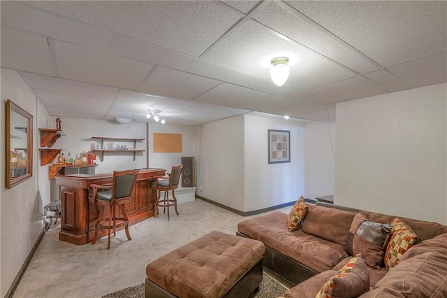 21212 E 52nd Street Ct, Blue Springs, MO 64015 - living area featuring baseboards, a bar, and a paneled ceiling