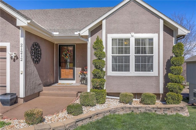 21212 E 52nd Street Ct, Blue Springs, MO 64015 - entrance to property with stucco siding and roof with shingles