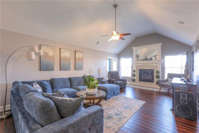 21212 E 52nd Street Ct, Blue Springs, MO 64015 - living room featuring vaulted ceiling, a ceiling fan, a tile fireplace, and dark wood-style floors