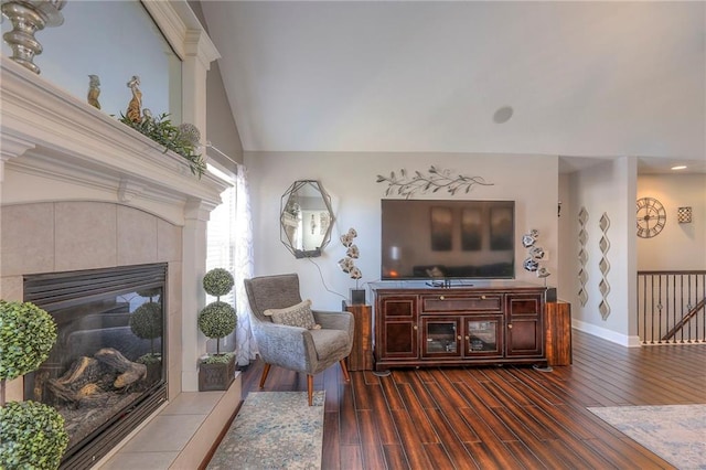 21212 E 52nd Street Ct, Blue Springs, MO 64015 - living room with dark wood-type flooring, lofted ceiling, a fireplace, and baseboards