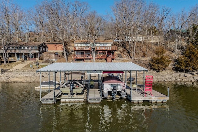 dock area with a water view and boat lift