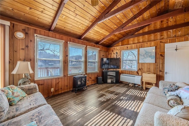 living room with wooden walls, wood finished floors, lofted ceiling with beams, a wood stove, and wooden ceiling