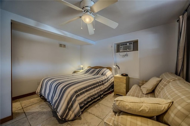 bedroom featuring an AC wall unit, a ceiling fan, visible vents, and baseboards