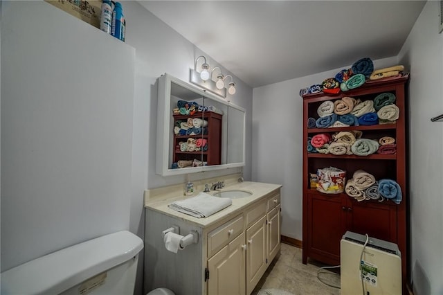 half bathroom with vanity, toilet, and visible vents