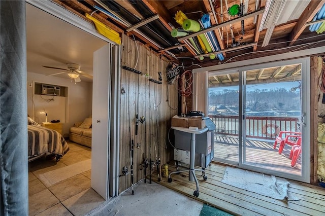 misc room featuring ceiling fan and a wall unit AC